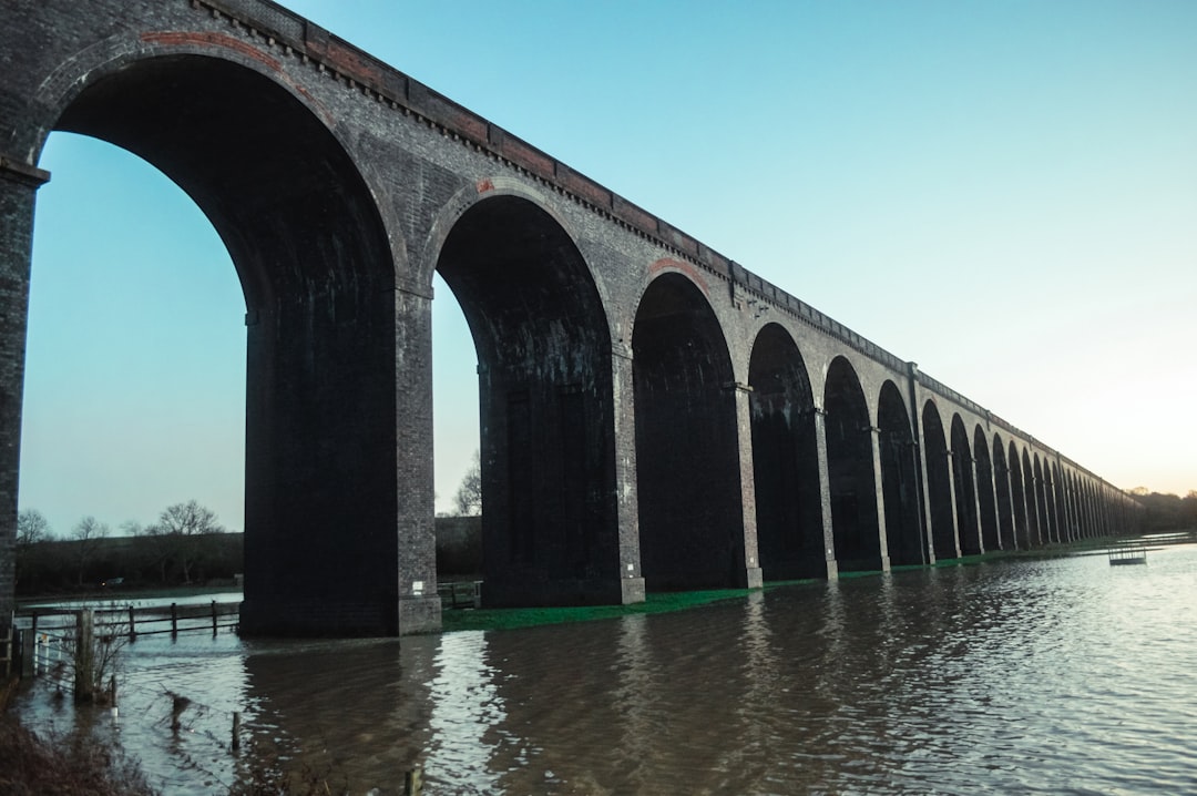 Sunset over a viaduct with water reflection